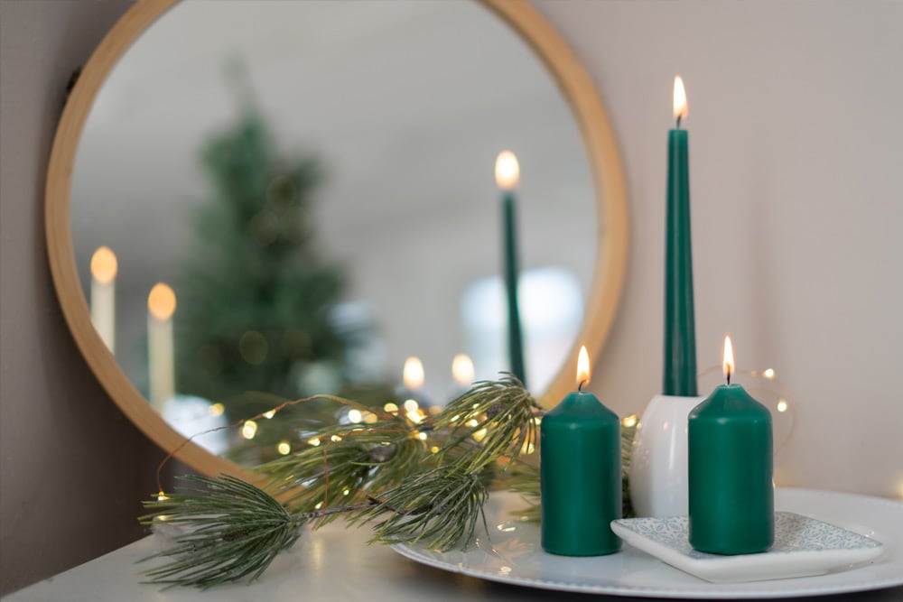 Bunte Kerzen mit weihnachtlicher Dekoration